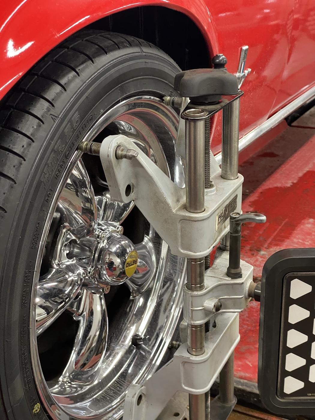 Close-up of an alignment clamp on a chrome wheel